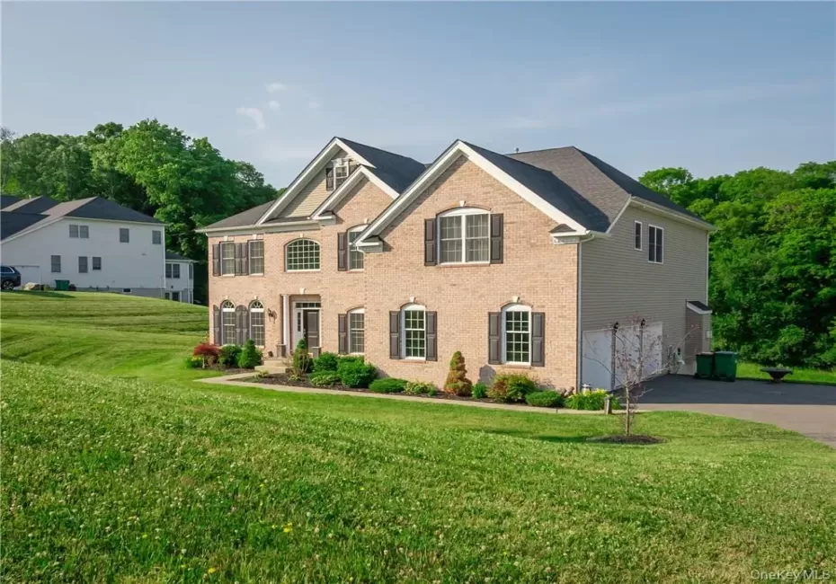 View of front of house featuring a garage and a front lawn View of front of house featuring a garage and a front lawn