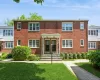 View of front of property with a front yard and brick siding View of front of property with a front yard and brick siding
