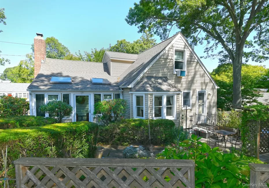 View of house featuring a chimney and roof with shingles View of house featuring a chimney and roof with shingles
