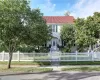 View of front of property with a tiled roof, a gate, and a fenced front yard View of front of property with a tiled roof, a gate, and a fenced front yard