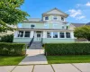 Residence featuring a light green siding and a prominent bay window structure Residence featuring a light green siding and a prominent bay window structure