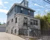 Stone and siding exterior with wrought iron railing, concrete stairs, and security bars Stone and siding exterior with wrought iron railing, concrete stairs, and security bars