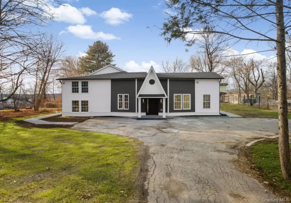 View of front facade featuring asphalt driveway and a shingled roof View of front facade featuring asphalt driveway and a shingled roof