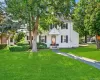 Colonial inspired home with a front yard Colonial inspired home with a front yard
