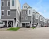 View of front of home with stairs, a residential view, asphalt driveway, and a carport View of front of home with stairs, a residential view, asphalt driveway, and a carport