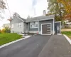 View of front of house featuring a front lawn, asphalt driveway, a chimney, a garage, and a shingled roof View of front of house featuring a front lawn, asphalt driveway, a chimney, a garage, and a shingled roof