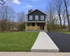 View of front of property with covered porch and a front yard View of front of property with covered porch and a front yard