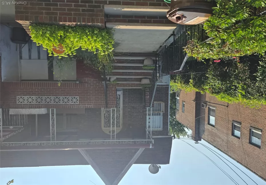View of front facade with brick siding and a porch View of front facade with brick siding and a porch