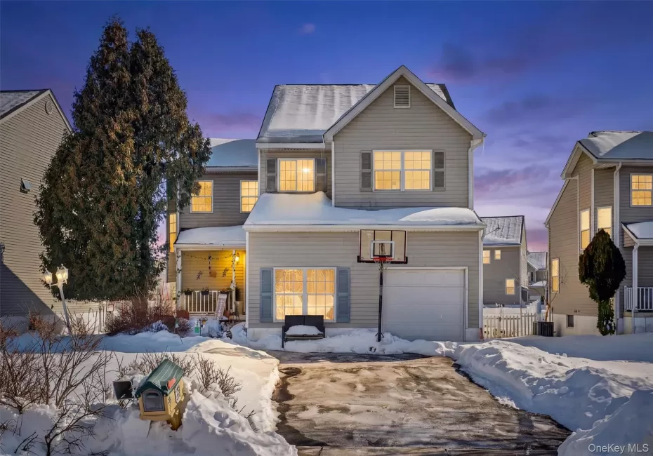 Traditional-style house featuring an attached garage Traditional-style house featuring an attached garage
