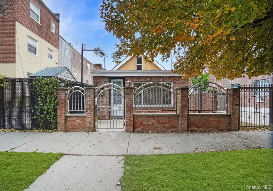 View of front of property with a fenced front yard, brick siding, and a gate View of front of property with a fenced front yard, brick siding, and a gate