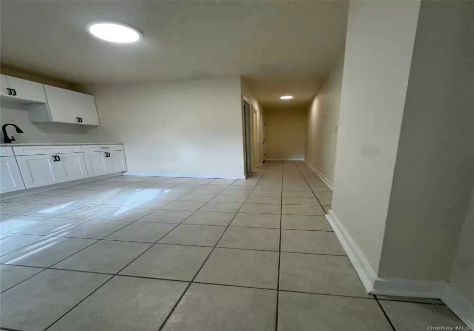 Unfurnished dining area featuring light tile patterned flooring and baseboards Unfurnished dining area featuring light tile patterned flooring and baseboards