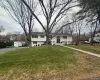 Bi-level home with a front yard and asphalt driveway Bi-level home with a front yard and asphalt driveway