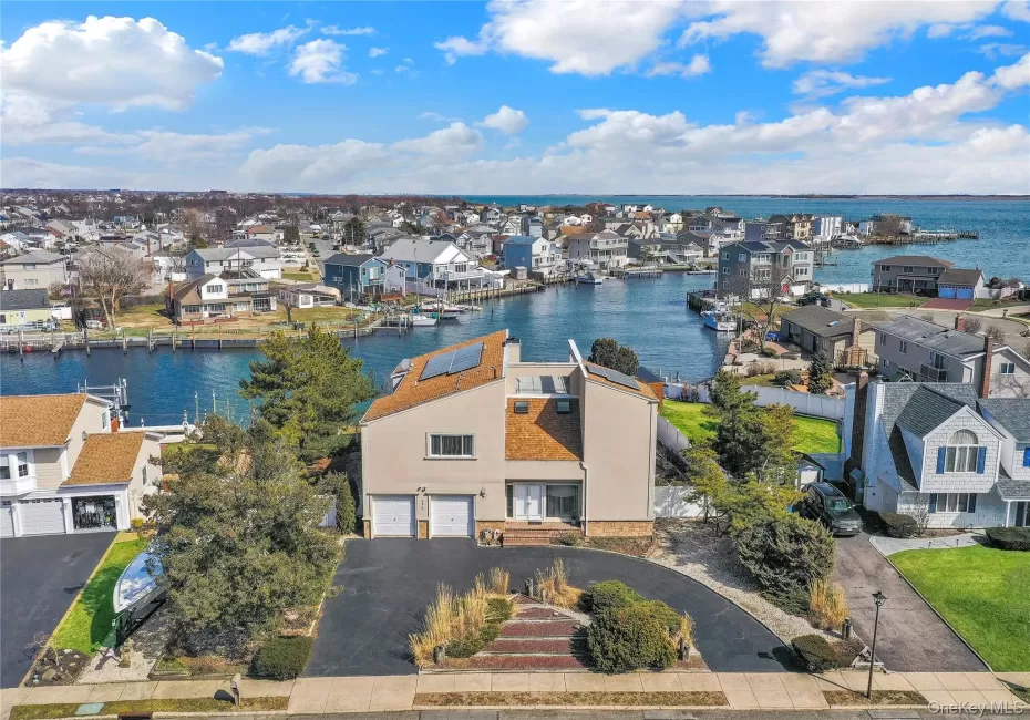 Aerial view of residential area featuring a nearby body of water Aerial view of residential area featuring a nearby body of water