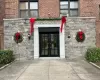 Doorway to property featuring stone siding, french doors, and brick siding Doorway to property featuring stone siding, french doors, and brick siding
