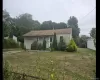 Ranch-style house with an attached garage and view of scattered trees Ranch-style house with an attached garage and view of scattered trees