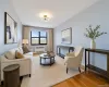 Living area with light wood-style floors and radiator heating unit Living area with light wood-style floors and radiator heating unit