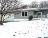 View of snow covered exterior with a wooden deck View of snow covered exterior with a wooden deck