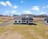 View of front facade with roof with shingles, a view of countryside, and gravel driveway View of front facade with roof with shingles, a view of countryside, and gravel driveway