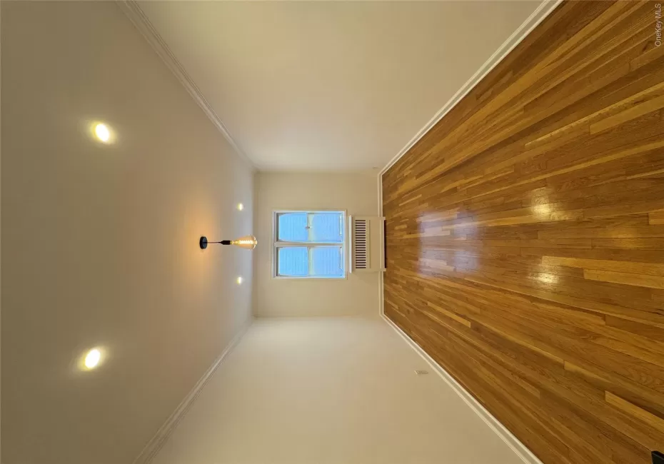 Spare room featuring ornamental molding, hardwood / wood-style floors, radiator, and recessed lighting Spare room featuring ornamental molding, hardwood / wood-style floors, radiator, and recessed lighting