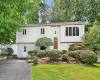 Raised ranch featuring stucco siding and driveway Raised ranch featuring stucco siding and driveway