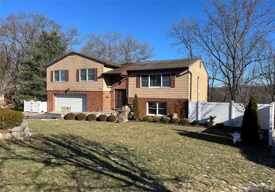 View of front of home featuring a garage and a front lawn View of front of home featuring a garage and a front lawn