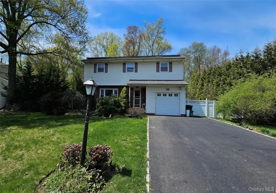 New City Colonial with large driveway and a tree lined street New City Colonial with large driveway and a tree lined street