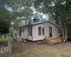 View of front facade featuring a wooden deck View of front facade featuring a wooden deck