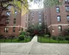 View of apartment building / complex featuring a fenced front yard View of apartment building / complex featuring a fenced front yard