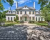 Classic white brick facade with a prominent central entrance, flanked by twin chimneys Classic white brick facade with a prominent central entrance, flanked by twin chimneys