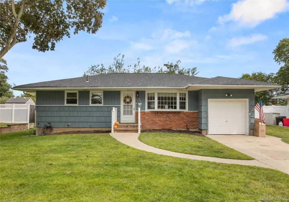 Ranch-style house with an attached garage, concrete driveway, and roof with shingles Ranch-style house with an attached garage, concrete driveway, and roof with shingles