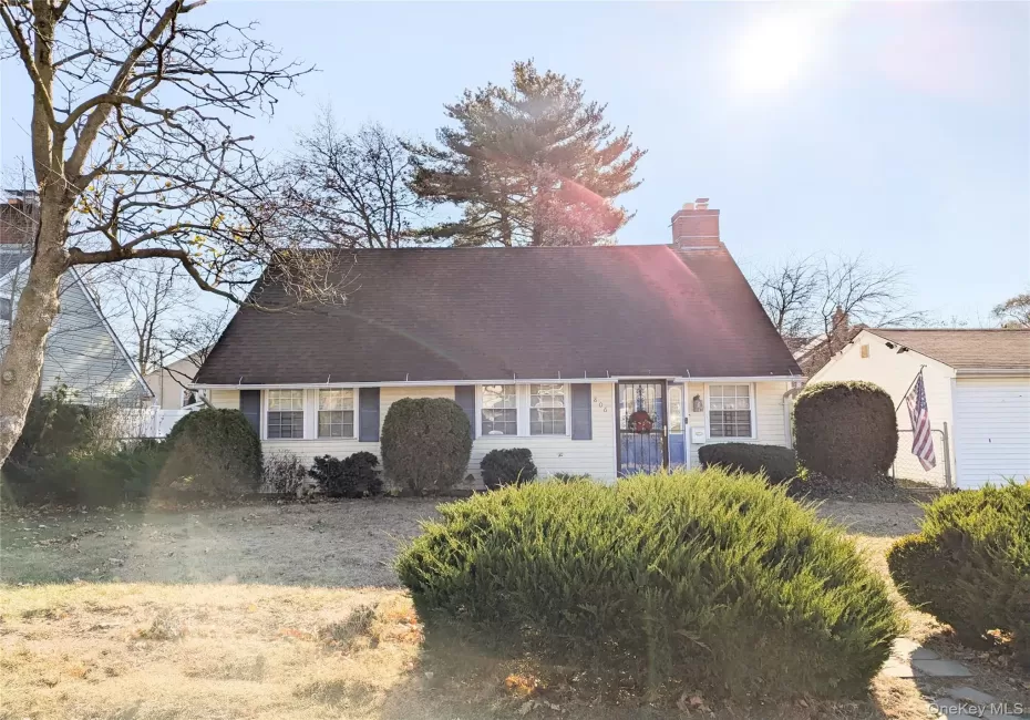 Cape cod home with a front yard Cape cod home with a front yard