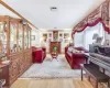 Living area with light wood-type flooring, a fireplace, and crown molding Living area with light wood-type flooring, a fireplace, and crown molding