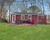 Rear view of house featuring a yard, roof with shingles, and a patio Rear view of house featuring a yard, roof with shingles, and a patio