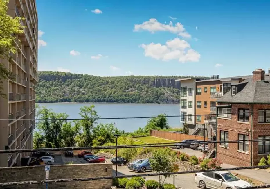 Expansive water frontage with a distant wooded cliffside Expansive water frontage with a distant wooded cliffside