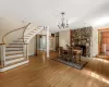 Great room w dining area, wood floors, staircase and a fireplace with wb incert Great room w dining area, wood floors, staircase and a fireplace with wb incert
