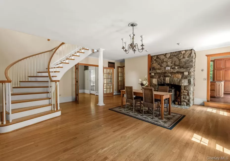 Great room w dining area, wood floors, staircase and a fireplace with wb incert Great room w dining area, wood floors, staircase and a fireplace with wb incert