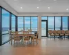 Dining space featuring a water view, light wood finished floors, healthy amount of natural light, and recessed lighting Dining space featuring a water view, light wood finished floors, healthy amount of natural light, and recessed lighting