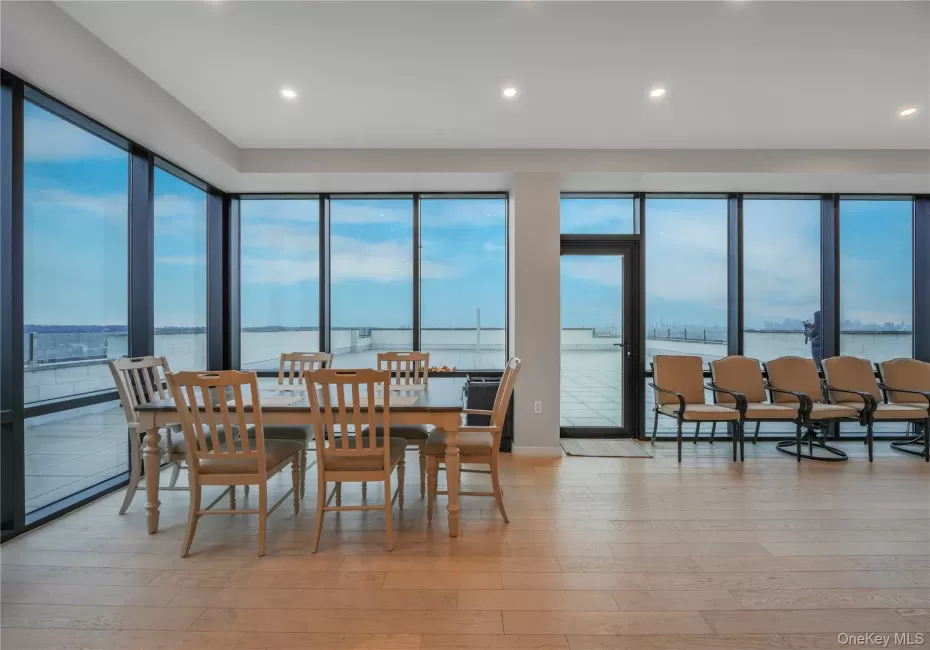 Dining space featuring a water view, light wood finished floors, healthy amount of natural light, and recessed lighting Dining space featuring a water view, light wood finished floors, healthy amount of natural light, and recessed lighting