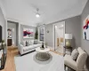 Living room featuring ceiling fan and light wood-style floors Living room featuring ceiling fan and light wood-style floors