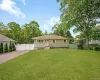 Ranch-style residence featuring a light-colored exterior with a front entry porch and a large front window Ranch-style residence featuring a light-colored exterior with a front entry porch and a large front window