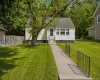 Cream-colored siding exterior with a dark-shingled roof Cream-colored siding exterior with a dark-shingled roof