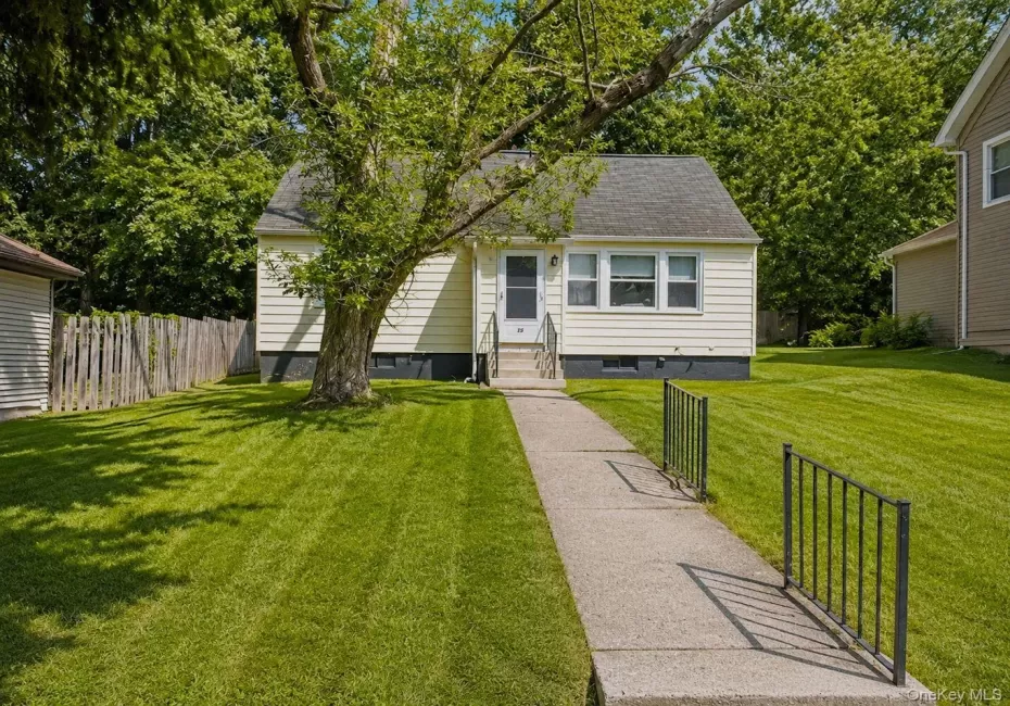 Cream-colored siding exterior with a dark-shingled roof Cream-colored siding exterior with a dark-shingled roof