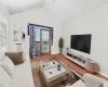 Living room with wood finished floors and lofted ceiling Living room with wood finished floors and lofted ceiling