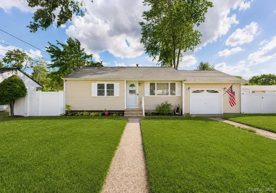 Ranch-style residence featuring light-colored siding and a single-car garage Ranch-style residence featuring light-colored siding and a single-car garage