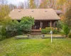 View of front of house featuring roof with shingles, a front lawn, and a porch View of front of house featuring roof with shingles, a front lawn, and a porch