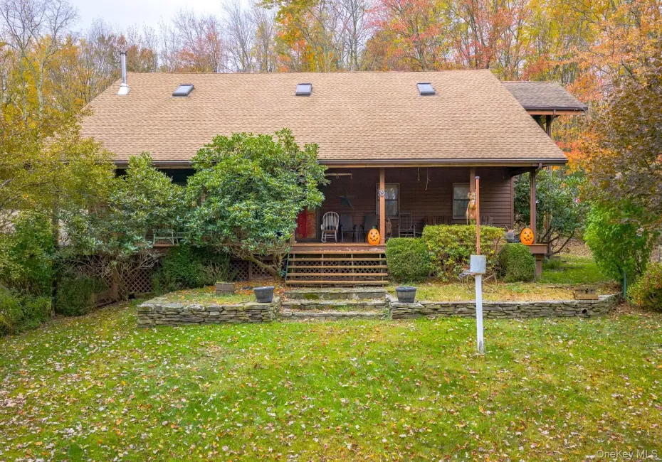 View of front of house featuring roof with shingles, a front lawn, and a porch View of front of house featuring roof with shingles, a front lawn, and a porch
