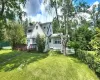 Rear view of house with a chimney and a deck Rear view of house with a chimney and a deck
