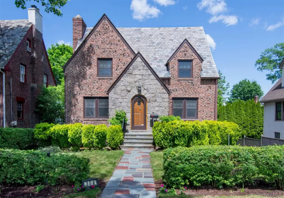 Impressive brick and stone Tudor with slate roof and elegant curb appeal Impressive brick and stone Tudor with slate roof and elegant curb appeal