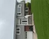 Split-level residence featuring gray shake siding and red brick accents Split-level residence featuring gray shake siding and red brick accents