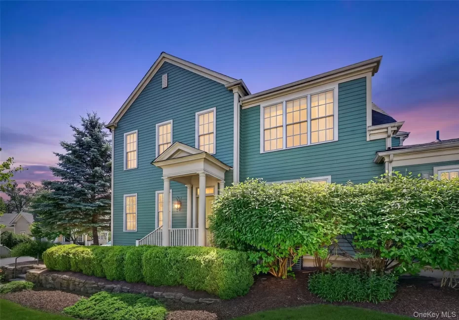 A beautiful twilight view highlights the home’s classic architecture, welcoming front entry, glowing windows, and mature landscaping. A beautiful twilight view highlights the home’s classic architecture, welcoming front entry, glowing windows, and mature landscaping.